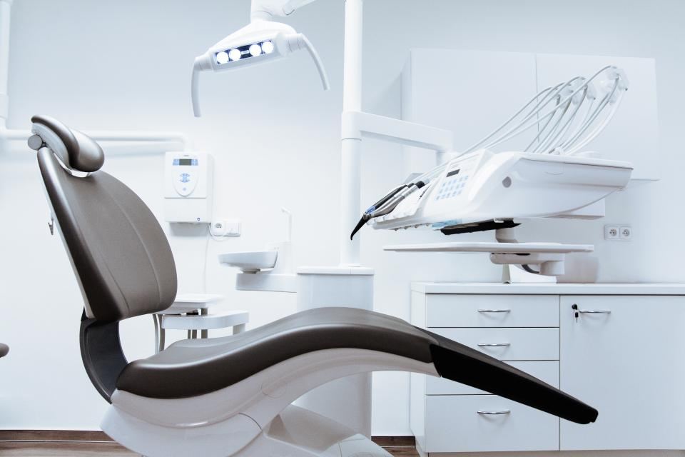 Empty dental treatment chair in a bright clinic room